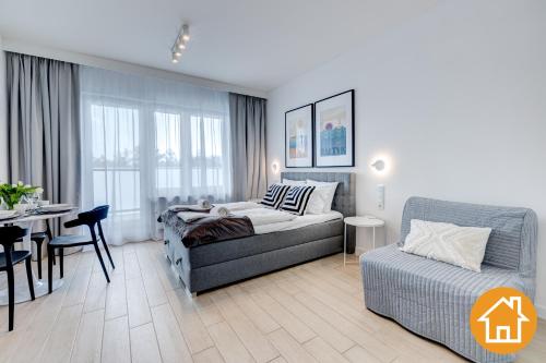ein Wohnzimmer mit einem Sofa und einem Tisch in der Unterkunft Apartamenty Aquamarina Onyx - visitopl in Misdroy