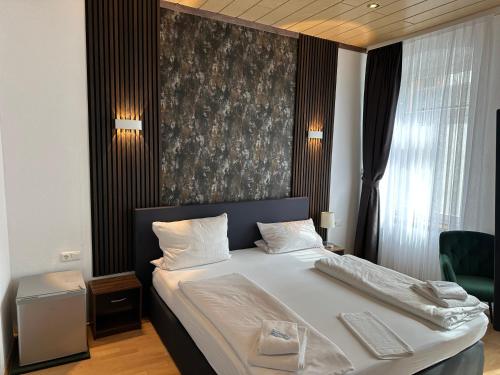 a bedroom with a bed with a black and gray wall at Hotel-Café-Burg Stahleck in Bacharach
