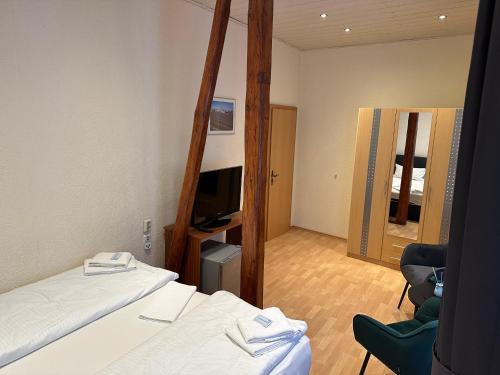 a hotel room with two beds and a mirror at Hotel-Café-Burg Stahleck in Bacharach