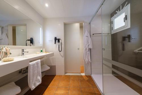a bathroom with a shower and a sink at Oassium Hotel - Adults Only in La Pineda