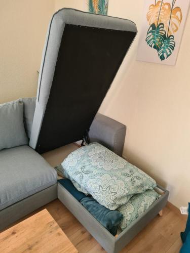 a living room with a couch and a pillow at Mulhouse by Hardt in Mulhouse