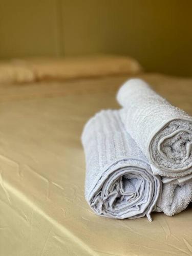 a stack of towels sitting on a bed at Los Jacintos Villa Sarita Posadas - 1A in Posadas