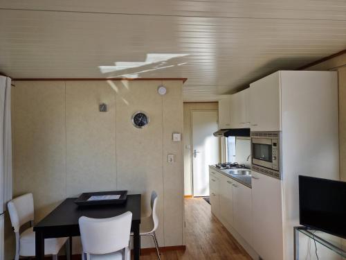 a small kitchen with a table and a dining room at kreeft 171 in Ballum