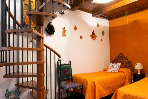 a room with a staircase and a table and a bed at LE STREGHE rooms e art con garage in Livorno