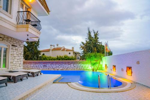 a swimming pool in the backyard of a house at The Fountain Hotel in Cesme