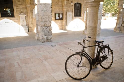a bike chained to a column in a building at Gaia Seaview Apartment 1 in Larnaka