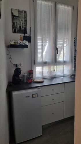 a kitchen with white cabinets and a counter top at La piccola Perla in Savona