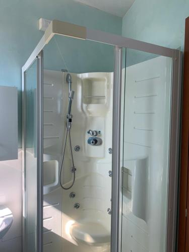 a shower in a bathroom with a glass door at Residence Giulia in Santa Maria Maddalena