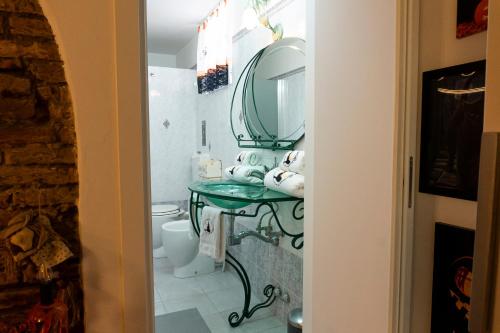 a bathroom with a sink and a mirror at LE STREGHE rooms e art con garage in Livorno