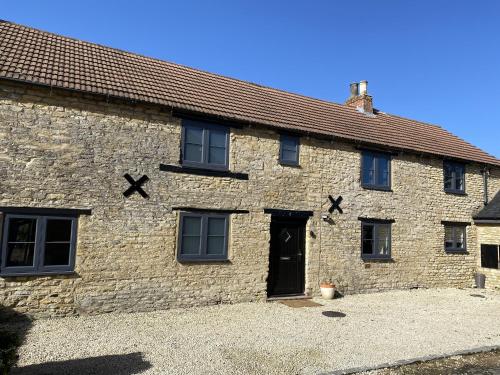an old stone building with crosses on it at The Roade House in Northampton