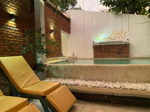 a bath tub sitting next to a brick building at Seconds Hostel - Colombo in Colombo