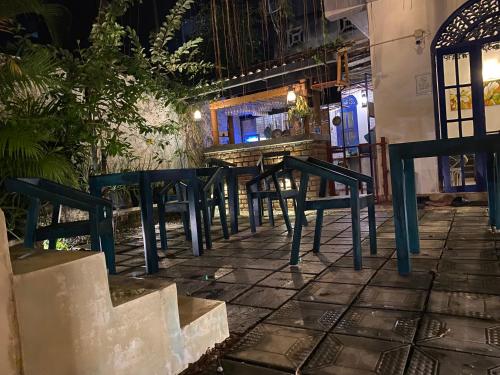 a row of chairs and a table in front of a bar at Seconds Hostel - Colombo in Colombo