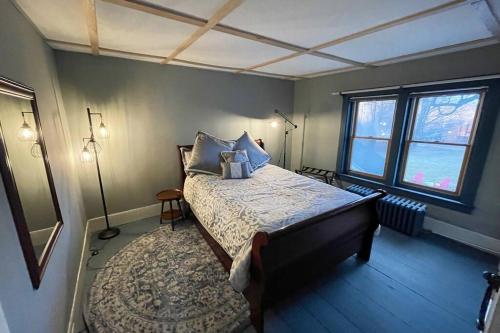 a bedroom with a bed and a large window at ADK Game House in Au Sable Forks