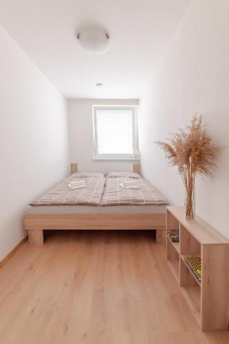 a large bed in a room with a window at Strawberry Apartment in Bratislava