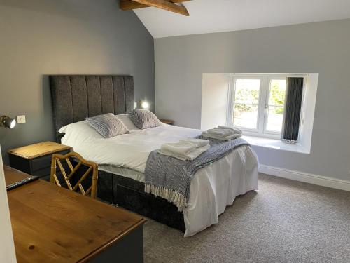 a bedroom with a large bed and a window at The Roade House in Northampton