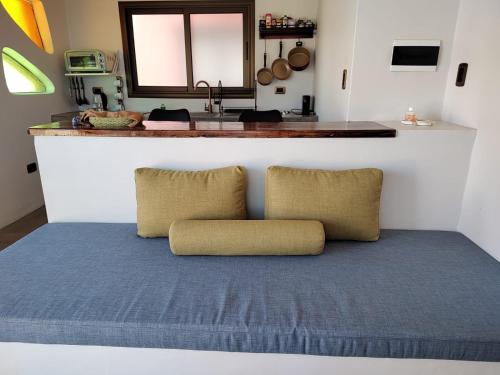 a room with a bed with two pillows on it at WAYTAY in Cafayate