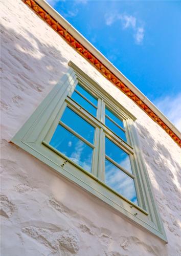 a window on the side of a building at Cotommatae Hydra 1810 in Hydra