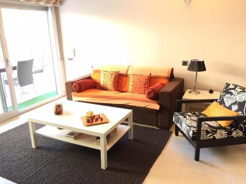 a living room with a couch and a coffee table at Saval Spa Aqquaria Family Complex in Salou