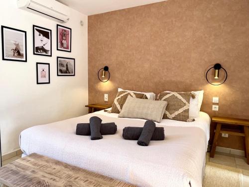 a bedroom with a large white bed with pillows at Domaine de Licetto in Bonifacio