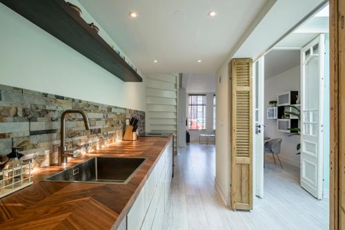 a kitchen with a sink and a counter at Luxury City Home Alkmaar nearby Amsterdam. in Alkmaar