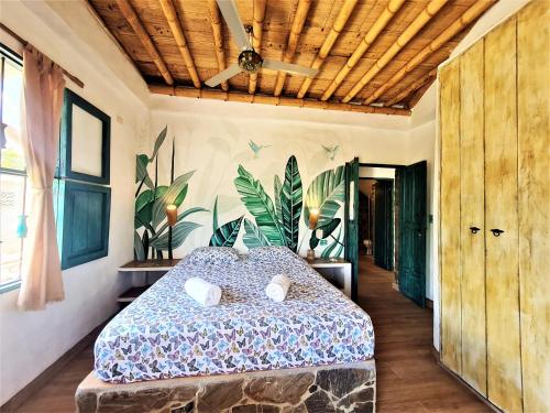 1 dormitorio con 1 cama y ventilador de techo en Casa frente al mar Chevere Beach, en Puebloviejo