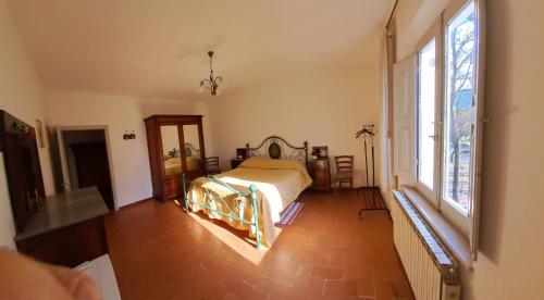 a bedroom with a bed and a large window at San Lorenzo in Cerreto dʼEsi