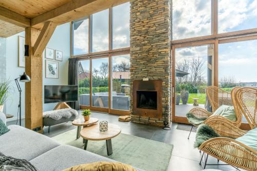 a living room with a stone fireplace at Buytenplaats Villa 183 in De Koog