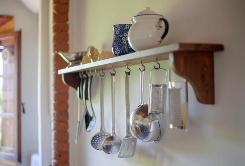 a bunch of utensils hanging on a wall at Castello del Calcione in Lucignano