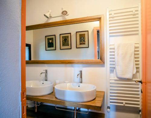 a bathroom with two sinks and a mirror at Castello del Calcione in Lucignano
