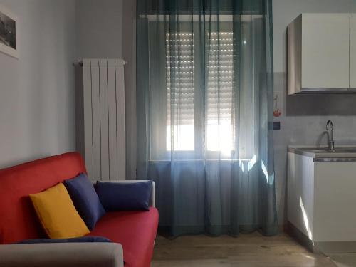 a living room with a couch and a window at Villa Nonno Nicola in Montenero di Bisaccia