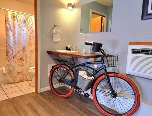 a bike parked in a bathroom with a sink at Buffalo Lodge Bicycle Resort - Amazing access to local trails & the Garden in Colorado Springs