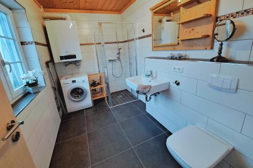 a bathroom with a sink and a washing machine at Ostsee Sonnengarten in Altefähr