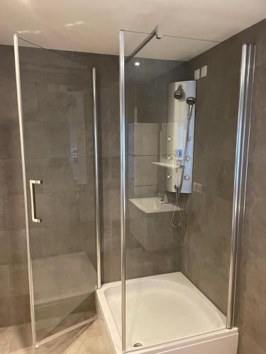 a shower with a glass door in a bathroom at Luxury City Home Alkmaar nearby Amsterdam. in Alkmaar