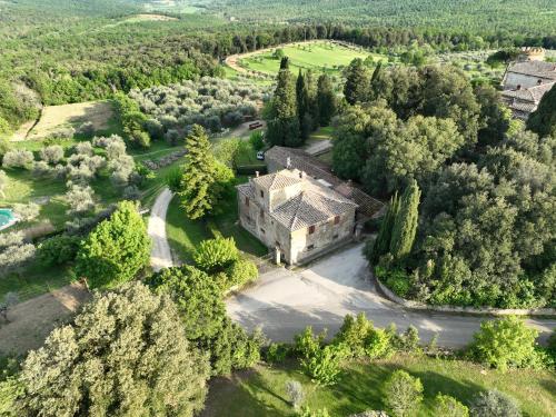 an aerial view of an old house in the forest at Castello del Calcione in Lucignano