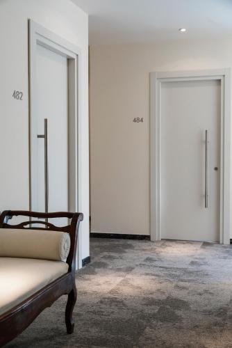a room with two doors and a bed in it at Europa Grand Hotel in Lerici