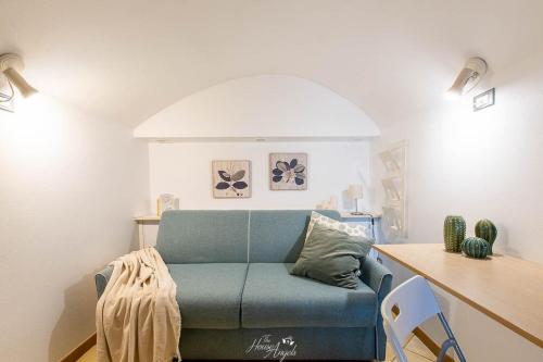 un salon avec un canapé bleu et une table dans l'établissement Vista mare e comfort in centro storico, à Menton