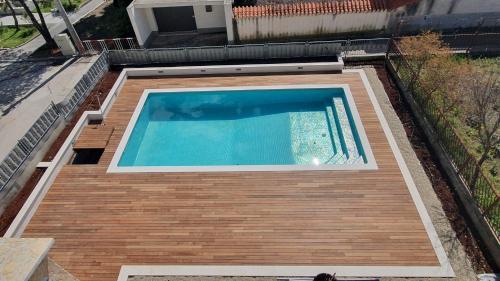 an overhead view of a swimming pool on a house at Apartments Meštrović with heated swiming pool- near Split in Kaštela