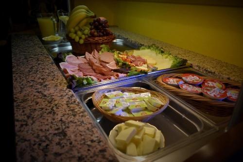 a buffet with meats and cheese and other foods on a counter at Pension Zum Erzgebirge in Kurort Altenberg