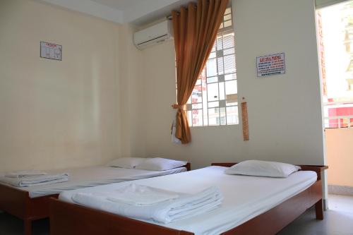 Giường trong phòng chung tại Ngoc Mai Guesthouse