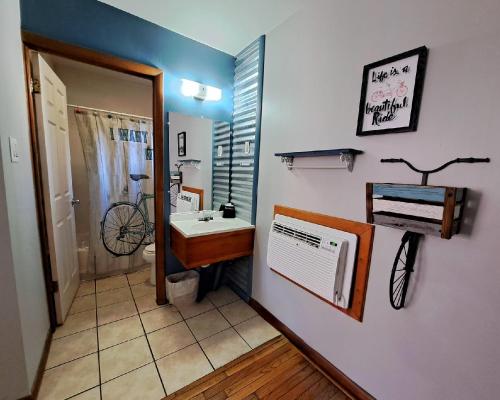 a bathroom with a sink and a bike on the wall at Buffalo Lodge Bicycle Resort - Amazing access to local trails & the Garden in Colorado Springs