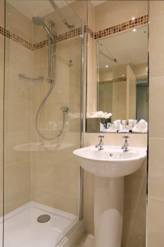 a bathroom with a sink and a shower at Macdonald Highlands Hotel at Macdonald Aviemore Resort in Aviemore