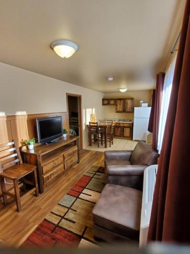 a living room with a couch and a flat screen tv at Bayside Resort, Lake George NY in Lake George