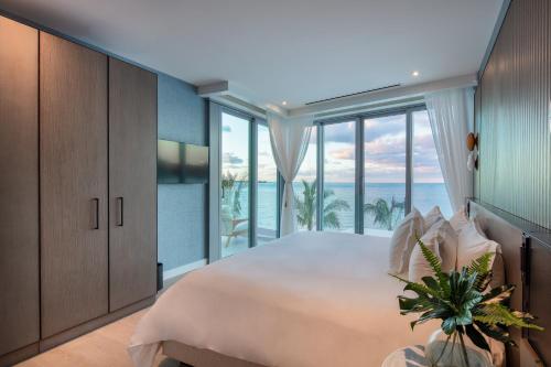 a bedroom with a large bed with a view of the ocean at Goldwynn Resort & Residences in Nassau
