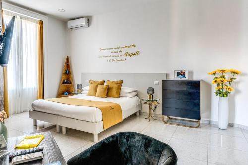a bedroom with a bed and a tv in it at Le Angioine Rooms in Naples