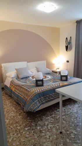 a bedroom with a bed with a table and a lamp at Casa dei sospiri in Polignano a Mare