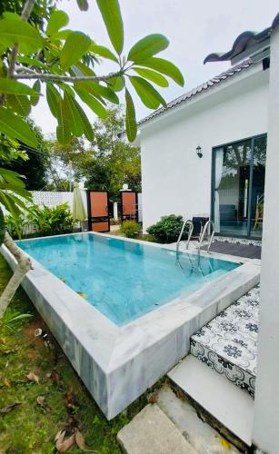a swimming pool in the backyard of a house at Summer Pool 2 Bedrooms Villa in Phu Quoc