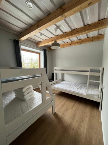 a room with two bunk beds and a ceiling at Prie Trakų in Petkėniškės