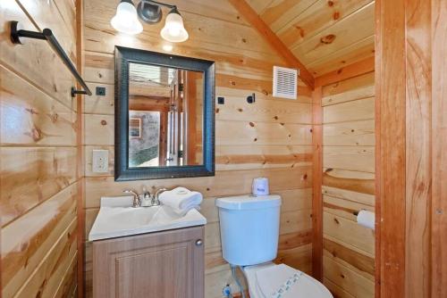 a bathroom with a toilet and a sink in a log cabin at Heated Pool Hot Tub Game Room Mountain Views in Sevierville
