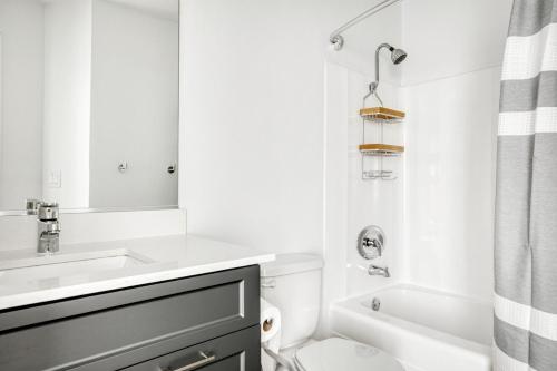 a white bathroom with a sink and a toilet at Redondo Beach 1BR w Pool Gym WD nr Beach LAX-613 in Redondo Beach