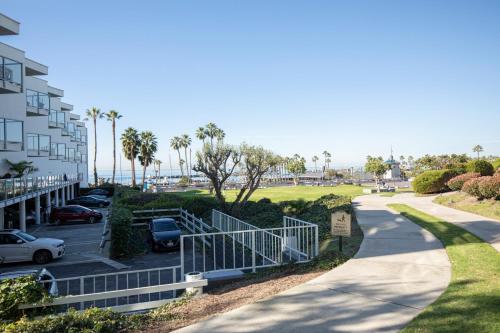 a walkway in front of a building with a parking lot at Redondo Beach 1BR w Pool Gym WD nr Beach LAX-613 in Redondo Beach